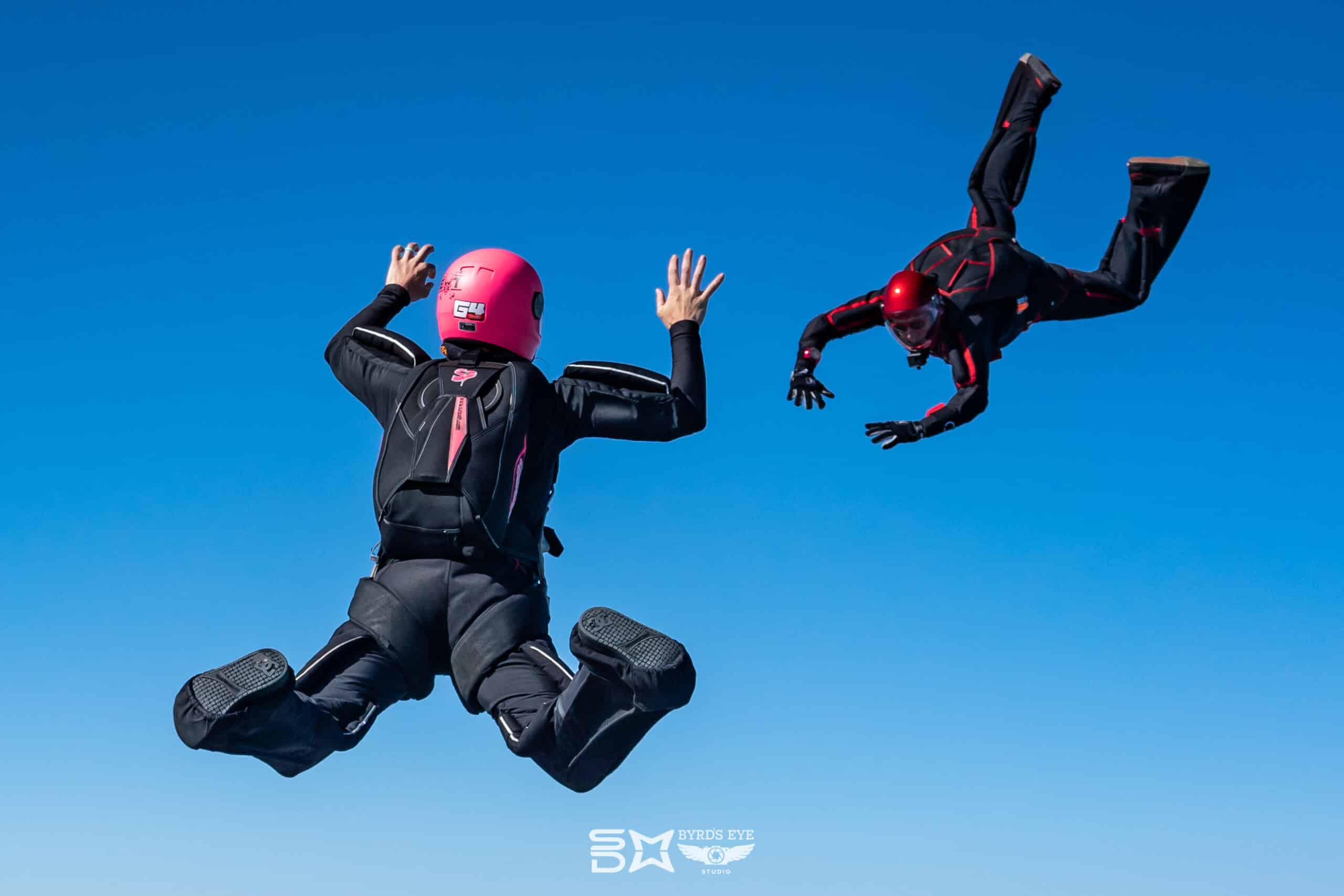 Skydiver approaching a waiting skydiver.