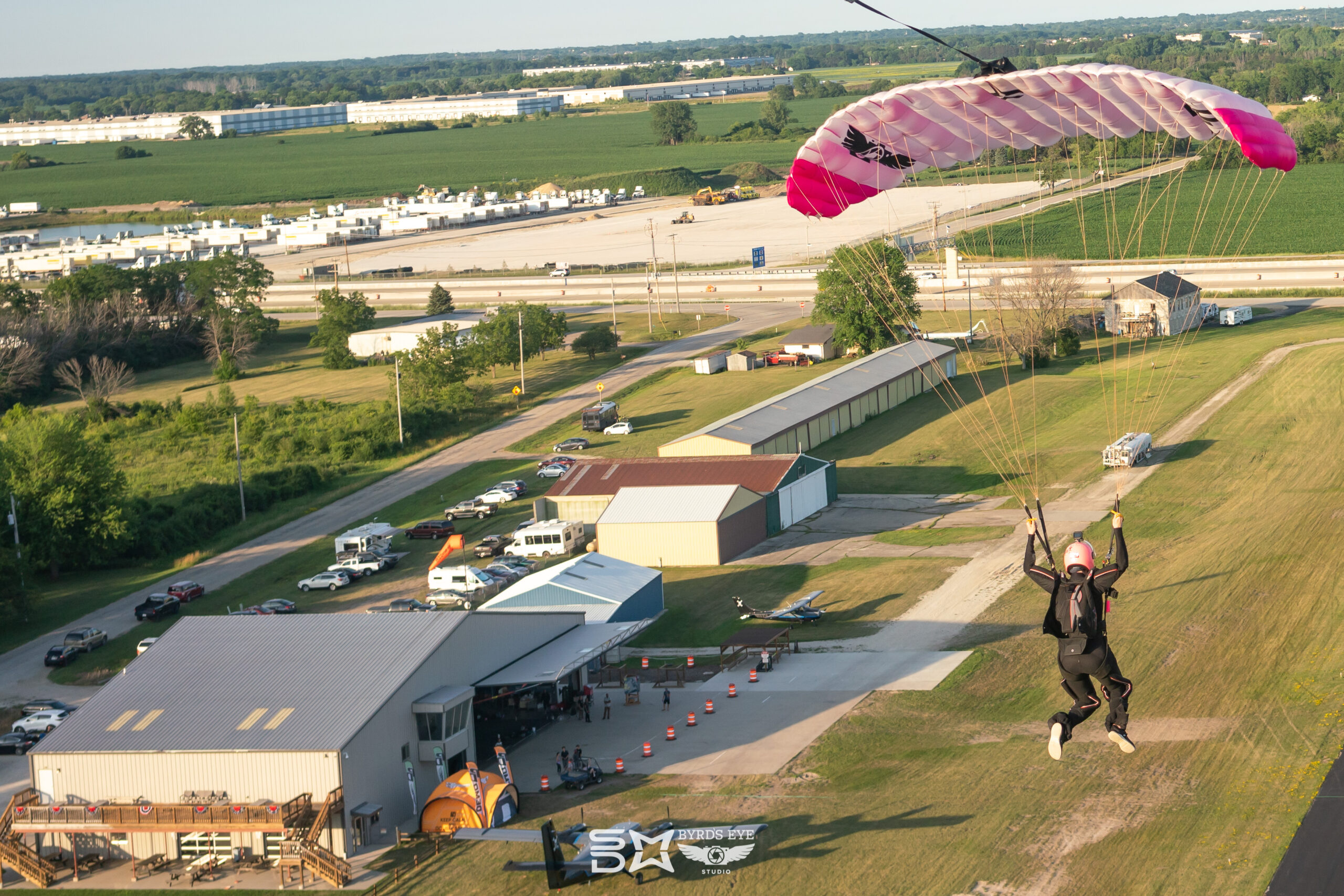 Skydiver flying their parachute over the landing area.