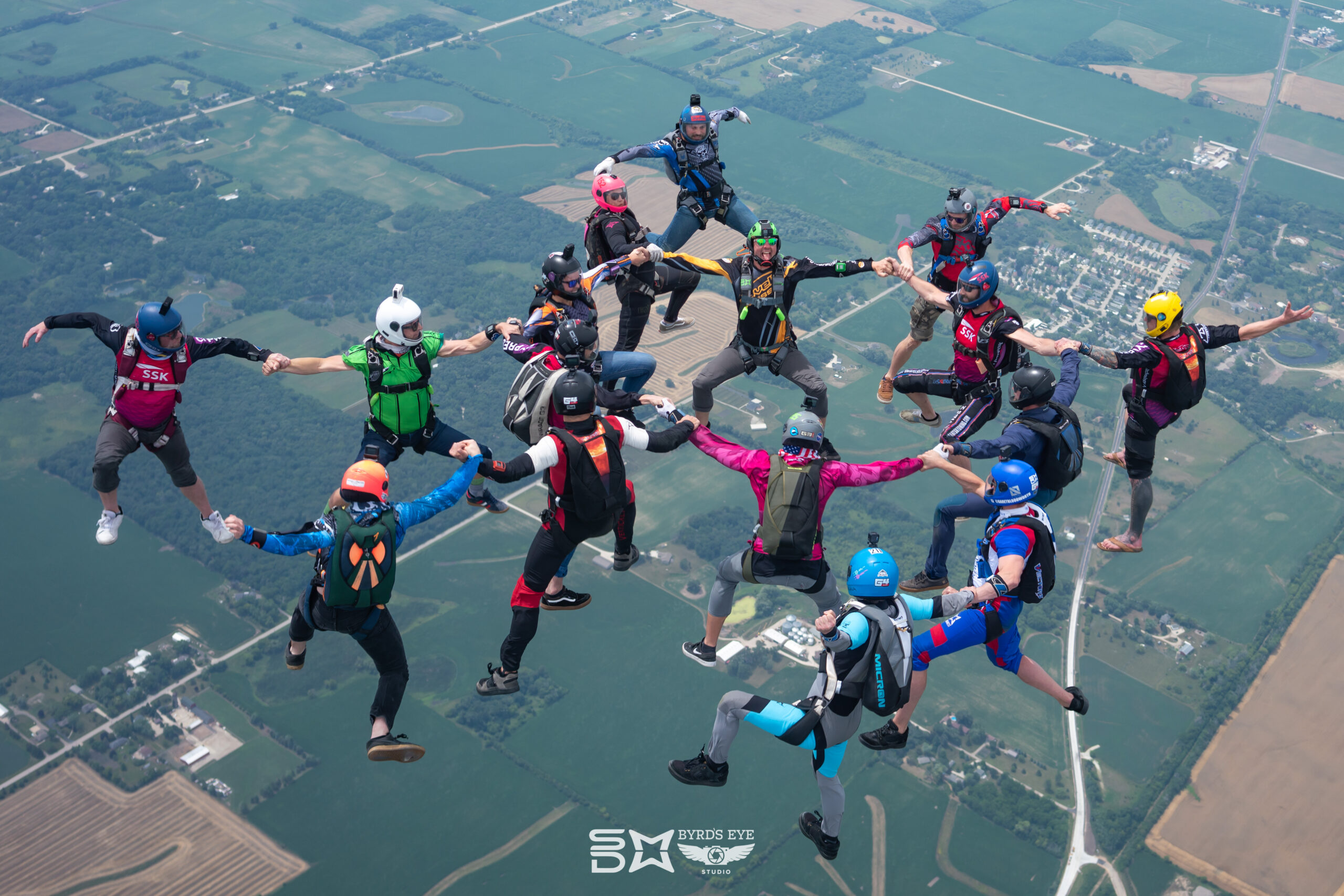 Experienced skydivers build a sit fly formation