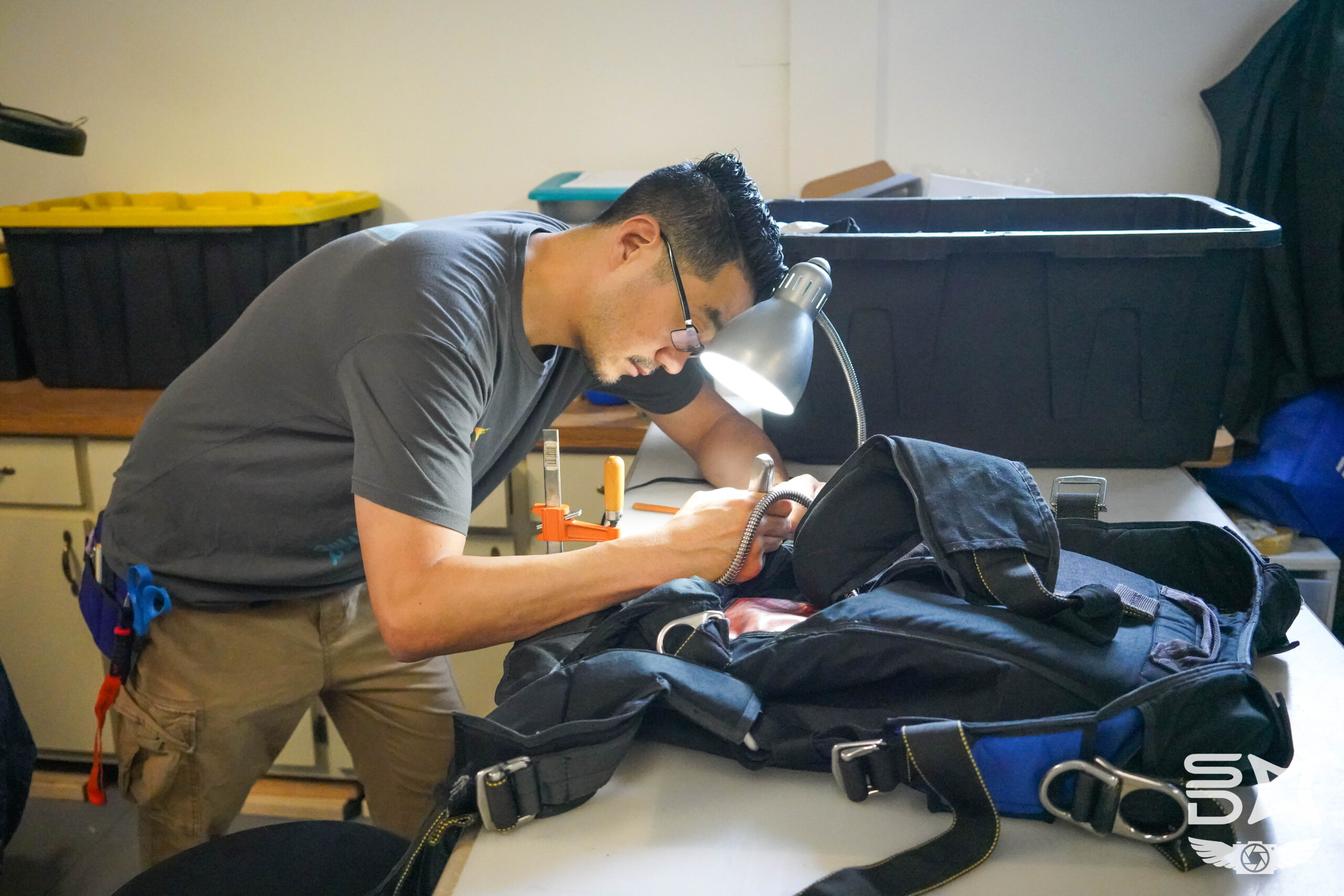 Kazu Oyama performing equipment maintenance at skydive midwest.