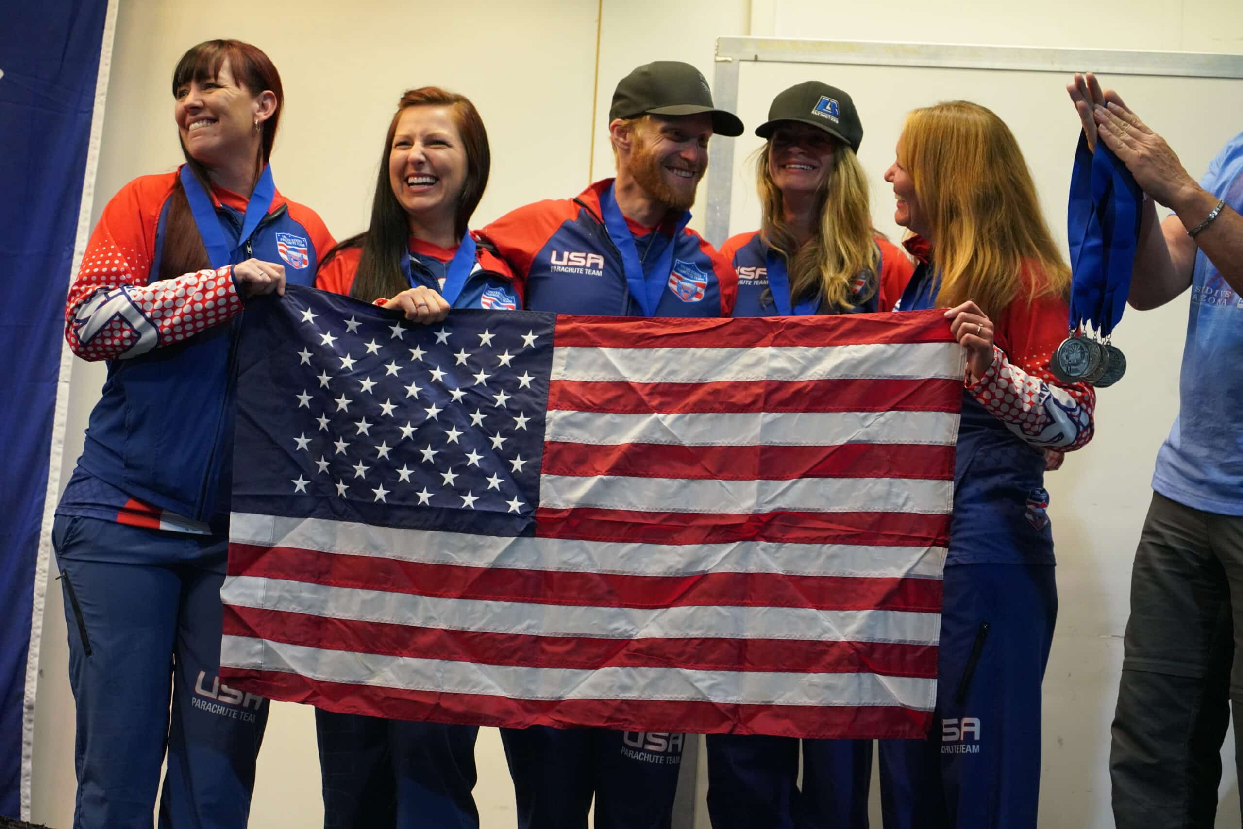 US 4 Way Team Holding American Flag