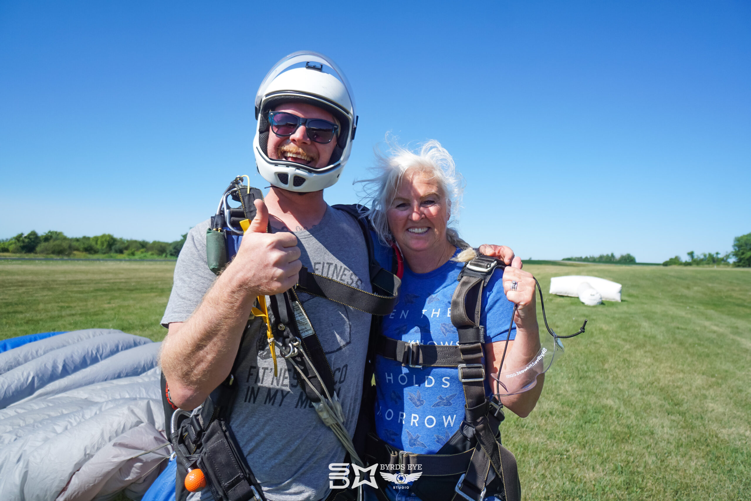 skydiving student gives thumbs up after jump