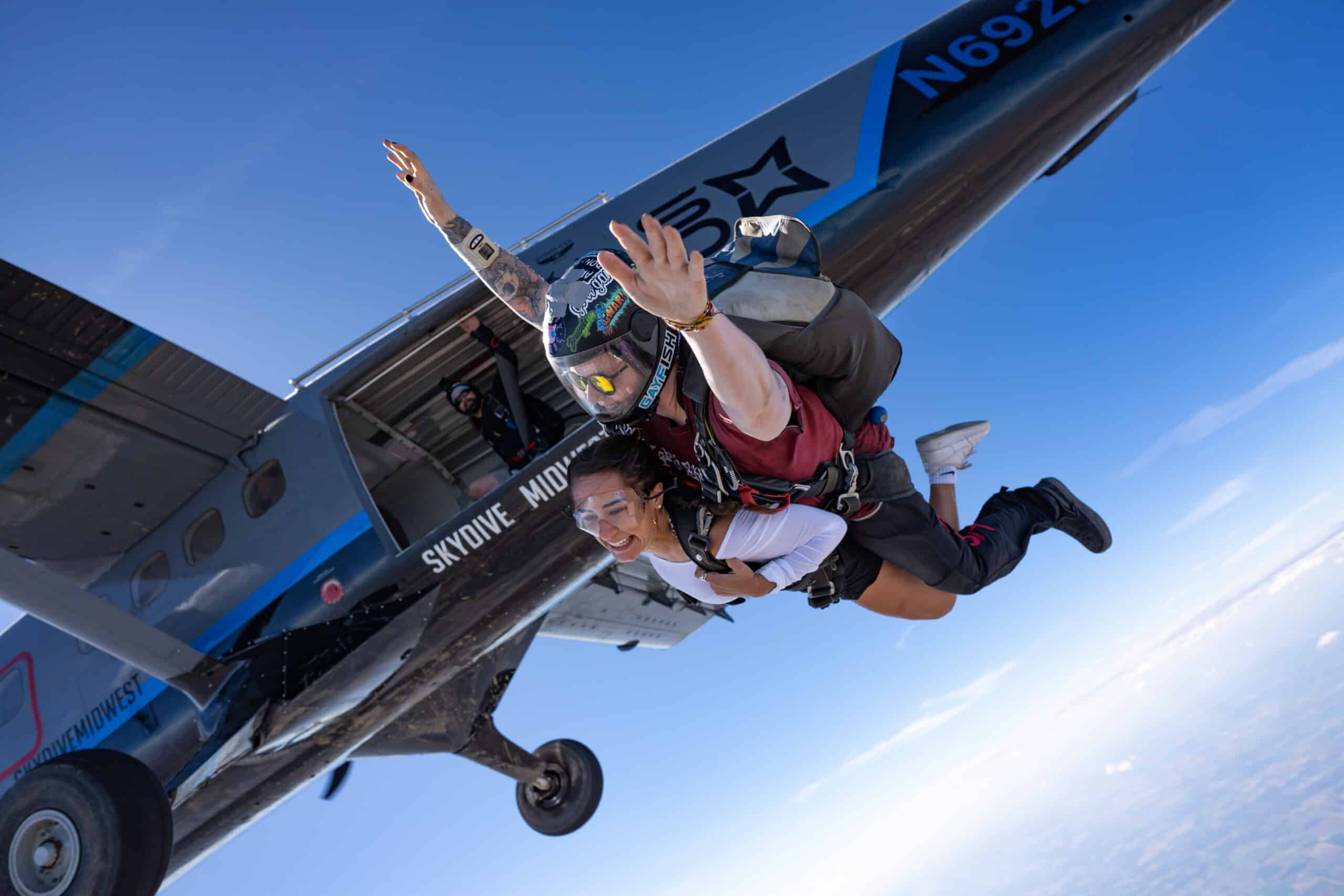 Tandem skydivers exit the plane at skydive midwest